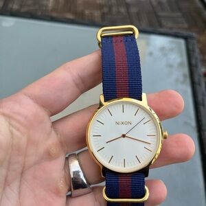 Nixon Gold Watch with Blue and Red Strap